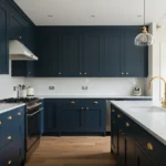 Contemporary kitchen with navy blue cabinets and gold hardware