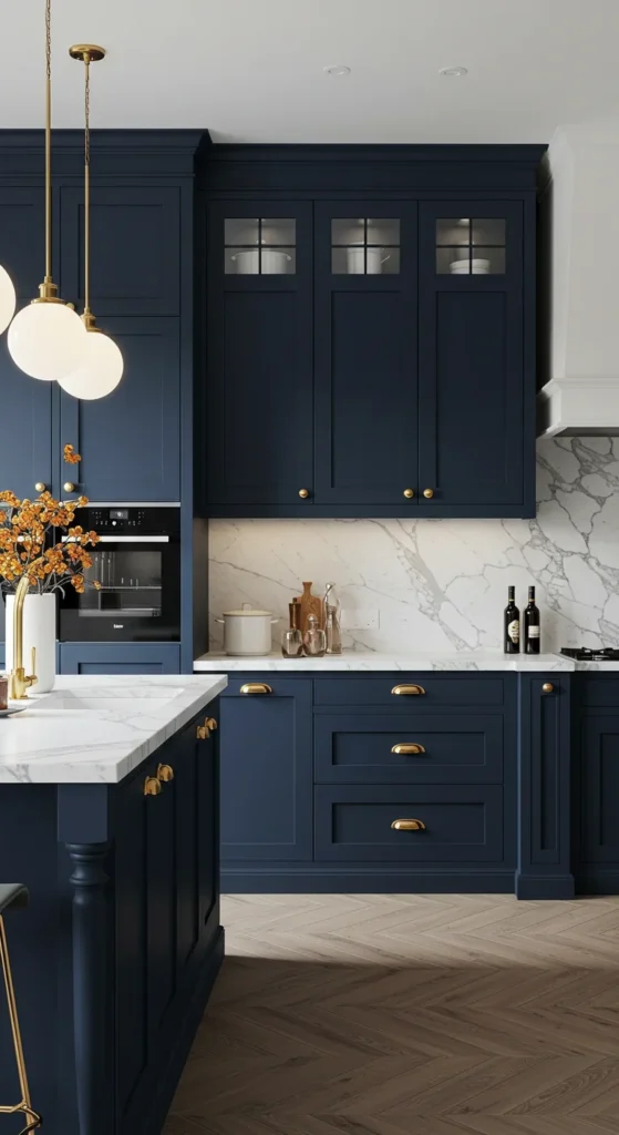 7 Blue Kitchen Ideas to Inspire a Cabinet Refresh Deep navy kitchen cabinets with gold hardware and marble tops