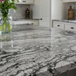 Modern kitchen with six types of countertops labeled for comparison